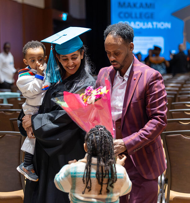 MaKami graduate with family at ceremony
