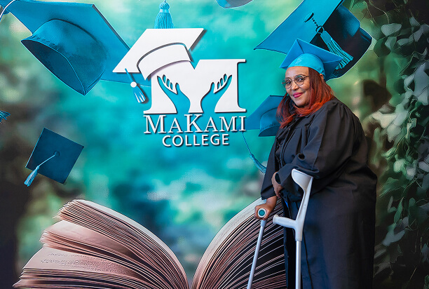 MaKami College graduate with crutch