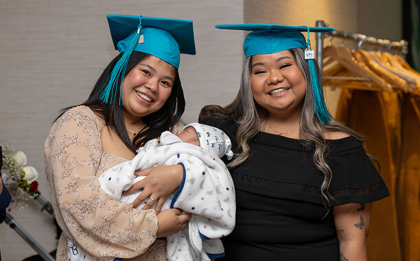 MaKami College graduates with a baby