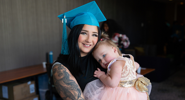 MaKami College student holding a child