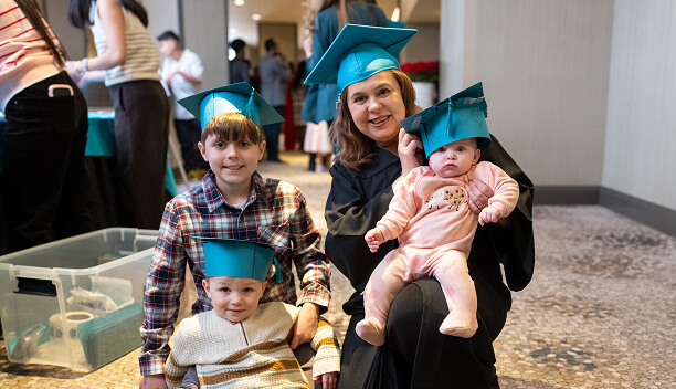 MaKami College graduate with her children